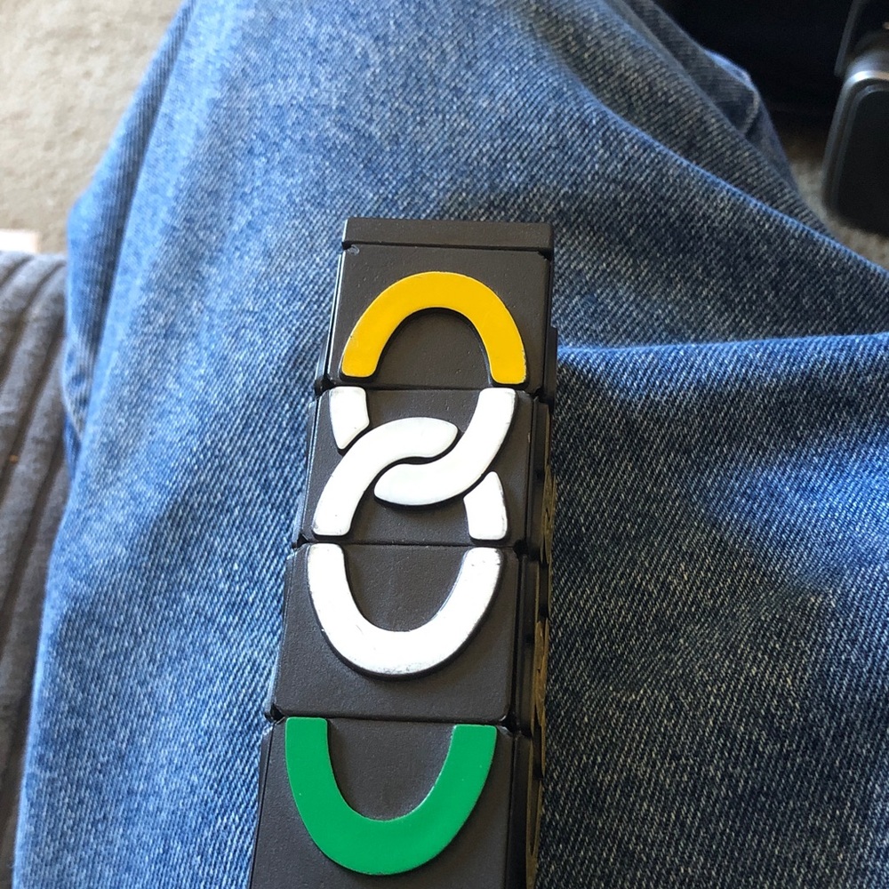 Black Modular Puzzle Wearable with Yellow, White, and Green Accents